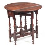AN UNUSUALLY SMALL EARLY 18TH CENTURY OAK OVAL GATE-LEG TABLE with turned baluster base raised on
