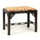 AN EARLY 20TH CENTURY CHINESE CHIPPENDALE STYLE CHINOISERIE STOOL with a drop-in upholstered seat,