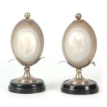 A PAIR OF LATE 19TH CENTURY AUSTRALIAN CAMEO EMU EGGS having shallow relief carved oval panels of