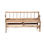 AN UNUSUAL ELM AND PINE REVERSIBLE BENCH with hinged backrest and plank seat; standing on joined