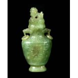 A 19TH CENTURY CHINESE JADE VASE AND COVER of baluster form with shallow carved decoration to the