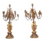 A LARGE PAIR OF LATE 19TH CENTURY BRASS 12 BRANCH FIGURAL CANDELABRA with rococo style branch work