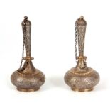 A PAIR OF 19TH CENTURY PERSIAN SILVER ROSEWATER BOTTLES of Islamic shape with chained covers and