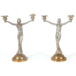 A PAIR OF ART DECO BRASS AND NICKEL FIGURAL CANDELABRA modelled as two ladies holding candle sconces