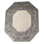 AN ARTS AND CRAFTS PEWTER OCTAGONAL HANGING MIRROR the embossed border depicting stylized swirling
