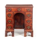 A GEORGE I WALNUT KNEEHOLE DESK the moulded edge top above graduated drawers fitted with gilt