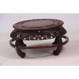 AN IMPRESSIVE 19TH CENTURY CHINESE HARDWOOD JARDINIERE STAND of circular form with panelled top