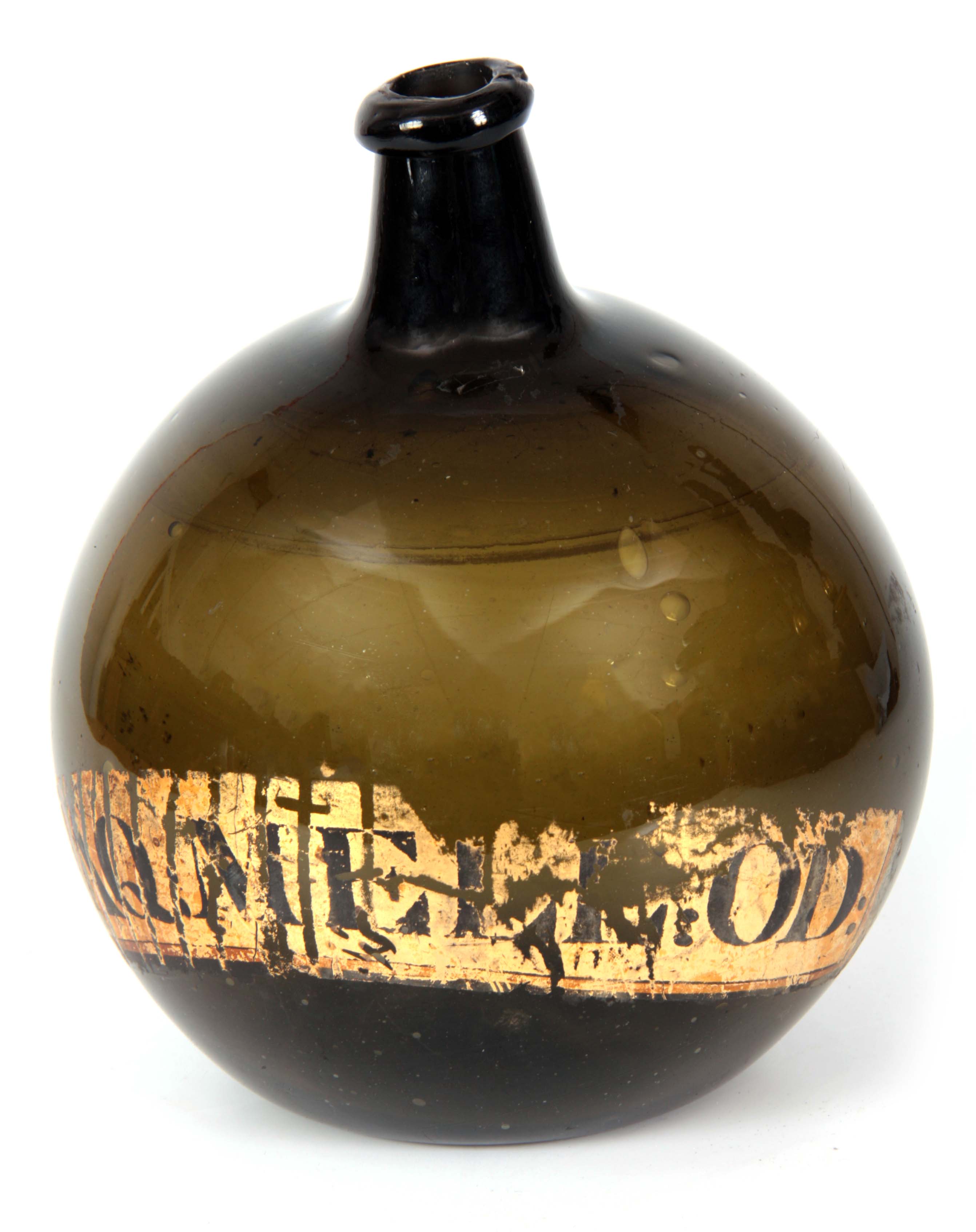 A LATE 18th CENTURY GREEN GLASS BOTTLE of bulbous form with a narrow neck, inscribed on the front