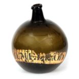 A LATE 18th CENTURY GREEN GLASS BOTTLE of bulbous form with a narrow neck, inscribed on the front