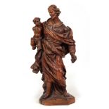 A 17TH CENTURY CONTINENTAL CARVED LIMEWOOD FIGURE OF A MAN AND YOUNG CHILD 92cm high.
