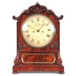 H. LYON, TROWBRIDGE A 19TH CENTURY FIGURED MAHOGANY BRACKET CLOCK with shaped pediment and carved