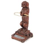 A STYLISH 19TH CENTURY BLACK FOREST CARVED DOG AND WHIP UMBRELLA/STICK STAND finely modelled