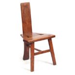 AN UNUSUAL 18TH CENTURY PRIMITIVE ELM COCK FIGHTING CHAIR with triangular plank seat and backrest;