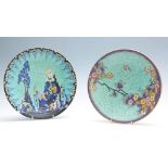 A CROWN DEVON FIELDINGS CIRCULAR HANGING SHALLOW DISH with colourful flower spray decoration on a