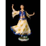 A MID 20th CENTURY RUSSIAN PORCELAIN FIGURE modelled as a lady dancer in traditional dress with gilt