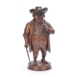 A 19TH CENTURY CARVED WALNUT TOBACCO JAR formed as a gentleman wearing an overcoat and hat smoking a