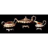 AN EARLY VICTORIAN IRISH SILVER MELON-SHAPED THREE PIECE TEA SERVICE with scroll handle and gilt