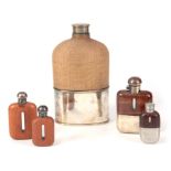 A COLLECTION OF FIVE HUNTING HIP FLASKS all silverplated and of various sizes with crocodile skin