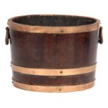 A 19TH CENTURY OAK COOPERED LOG BIN OF TAPERING FORM with brass bands and iron side handles 32cm