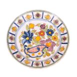 A LARGE 18TH CENTURY POLYCHROME DELFT CHARGER decorated with brightly coloured flowers and fruit -