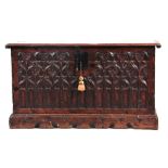A LATE 16TH/EARLY 17TH CENTURY AND LATER GOTHIC CARVED OAK COFFER with hinged lid above an arched c