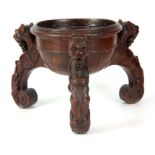 A 19TH CENTURY OAK COOPERED PLANT STAND with moulded edge raised on three scroll feet with