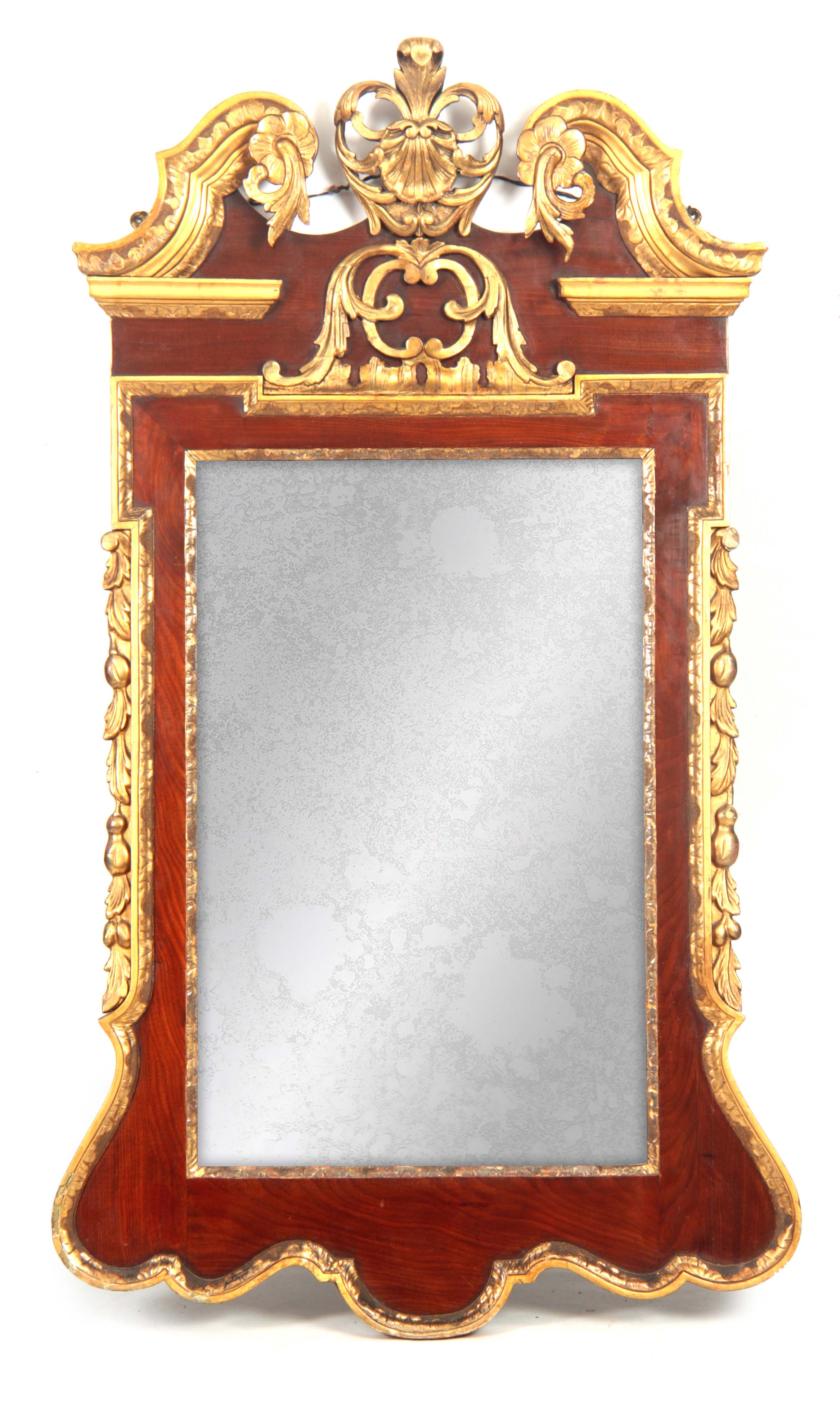 AN 18TH CENTURY MAHOGANY AND PARCEL GILT HANGING MIRROR with elaborate swan neck and shellwork