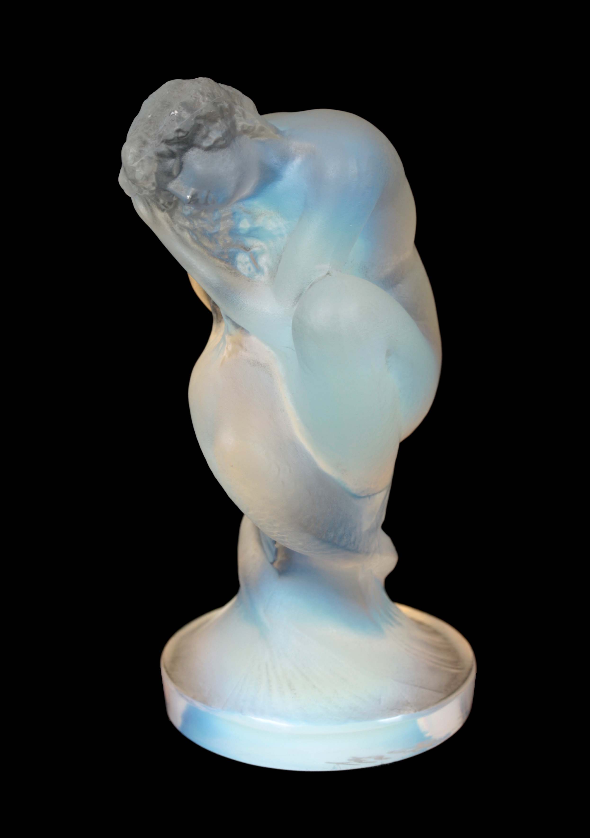 A RENE LALIQUE BLUE TINGED OPALESCENT GLASS CAR MASCOT 'SIRENE' modelled as a crouching mermaid 10cm