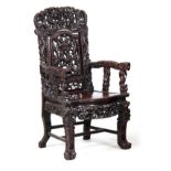 A 19TH CENTURY CHINESE HARDWOOD DRAGON ARMCHAIR the shaped back carved with dragons amongst clouds