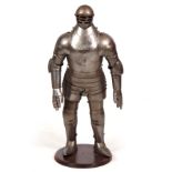 A MINIATURE SUITE OF ARMOUR mounted on a mahogany stand 80cm high.