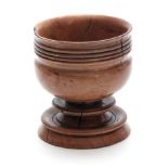 AN INTERESTING EARLY TURNED TREEN APPLEWOOD MASTER SALT having a ring decorated bulbous body 12cm