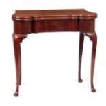 A MID 18TH CENTURY MAHOGANY CARD TABLE the hinged top having outswept corners revealing a baize