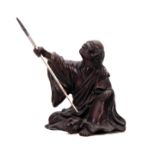 A MEIJI PERIOD JAPANESE PATINATED BRONZE FIGURE modelled as a seated man with spear 7.5cm high