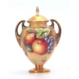 LEAMAN. A ROYAL WORCESTER GILT TWO-HANDLED PEDESTAL VASE AND COVER the ovoid body painted all