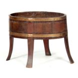 A GEORGE III LARGE OVAL MAHOGANY OPEN WINE COOLER with brass strapped body on flattened shaped