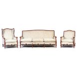 A 20TH CENTURY FRENCH ROCOCO STYLE CARVED BEECH THREE PIECE SUITE having shaped frames and loose