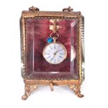 A 19TH CENTURY 18CT GOLD FOB WATCH IN GILT BRASS WATCH HOLDER watch weighs app.17g, the watch case