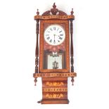 A LATE 19TH CENTURY WALNUT INLAID WALL CLOCK the case with carved pediment above an inlaid glazed