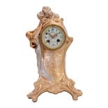 A GOLD AND SILVERED METAL ART NOUVEAU STYLE FIGURAL MANTEL CLOCK the case with young woman picking