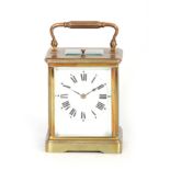 AN EARLY 20TH CENTURY FRENCH REPEATING BRASS CARRIAGE CLOCK having a corniche case enclosing an