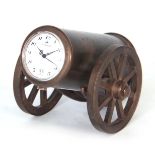 A 20TH CENTURY NOVELTY BRASS CLOCK formed as a cannon with wind up movement 11cm wide.