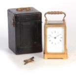 A 19TH CENTURY FRENCH STRIKING CARRIAGE CLOCK having a moulded brass frame enclosing an enamel Roman
