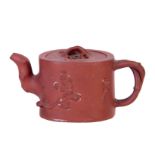 AN 18TH/19TH CENTURY CHINESE RED TERRACOTTA TEAPOT the oval body with branchwork handles and