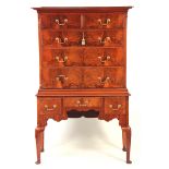 AN EARLY 20TH CENTURY FIGURED WALNUT CHEST ON STAND with moulded cornice above two small and three