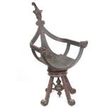 AN UNUSUAL 19TH CENTURY CARVED OAK REVOLVING CHAIR of boat-shaped openwork design with mask head