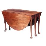 A GEORGE III MAHOGANY DROP LEAF DINING TABLE standing on turned leg supports with pad feet 122cm
