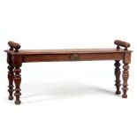 A VICTORIAN SIMULATED MAHOGANY WINDOW SEAT with turned side handles and tapering legs centred by