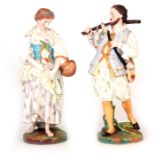 A COLOURFUL PAIR OF LATE 19TH CENTURY CONTINENTAL COLOURED BISCUIT-WARE STANDING FIGURES depicting a
