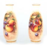 ROBERTS. A PAIR OF ROYAL WORCESTER BLACK MARK SLENDER OVOID VASES each painted with a panel of