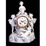 A LATE 19TH CENTURY MEISSEN STYLE BLANC DE CHINE FIGURAL MANTEL CLOCK decorated with cherubs holding